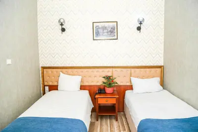 a room with two beds and a table with a plant at ASİTANE life HOTEL in Istanbul