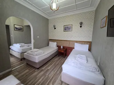 a hotel room with two beds and a mirror at ASİTANE life HOTEL in Istanbul