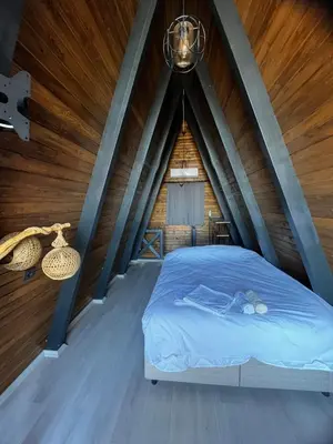 a bed in a room with a wooden ceiling at DREAM DELUXE SAPANCa in Sapanca