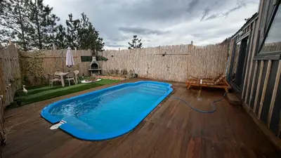 a swimming pool on a patio with a fence at DREAM DELUXE SAPANCa in Sapanca