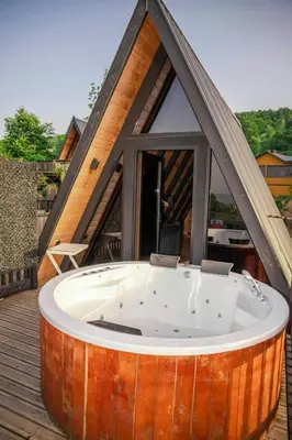 a large wooden tub on the deck of a house at Hill House Bungalov in Sapanca