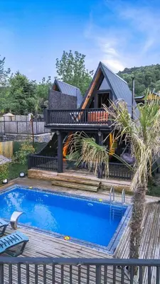 a house with a deck and a swimming pool at Hill House Bungalov in Sapanca