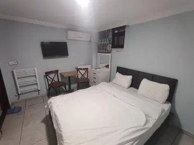 a bedroom with a white bed and a table and chairs at Taksim Luxury Mansion Hotel in Istanbul