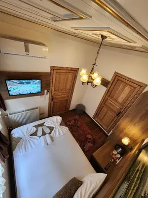 an overhead view of a bedroom with a bed and two doors at Kadıköy White House in Istanbul