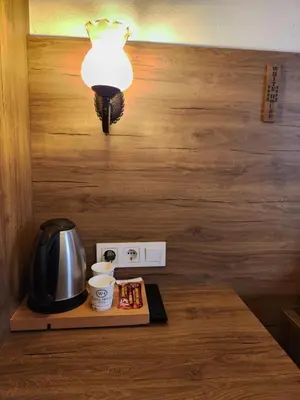 a table with a coffee pot and a light on it at Kadıköy White House in Istanbul