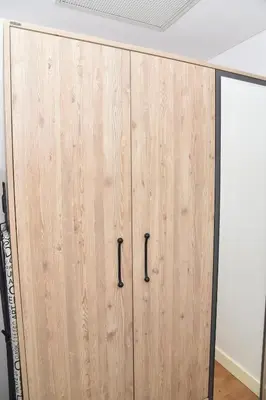 a wooden cabinet with black handles in a room at Safir Suite in Istanbul