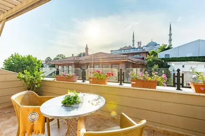 a balcony with a table and chairs and a view of a city at Best Point Hotel Sultanahmet,Istanbul in Istanbul