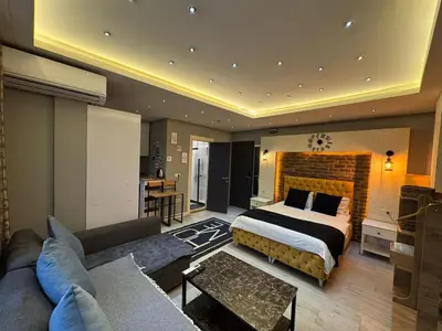 a bedroom with a bed and a living room at The Şişli No Va Park Suites in Istanbul