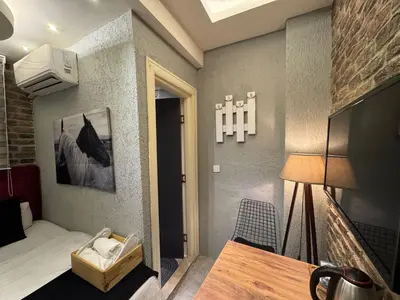 a small room with a bed and a table at The Şişli No Va Park Suites in Istanbul
