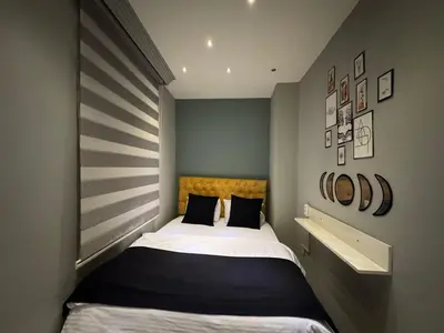 a small bedroom with a bed in a room at The Şişli No Va Park Suites in Istanbul