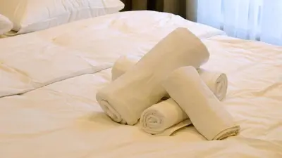 two rolled up towels sitting on a bed at Rodax Residence in Istanbul