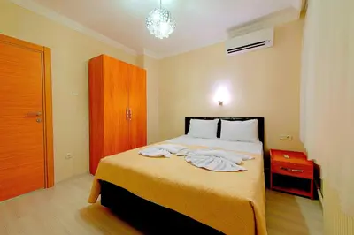 a bedroom with a bed with towels on it at Efe Apart Hotel in Istanbul