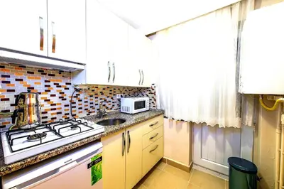 a small kitchen with a sink and a microwave at Efe Apart Hotel in Istanbul