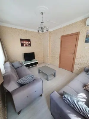 a living room with a couch and a table at Efe Apart Hotel in Istanbul