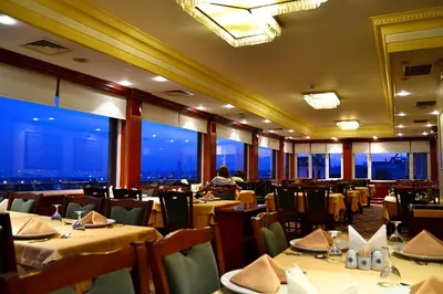 a restaurant with tables and chairs with a view at Hotel Erden Sarayevo in Istanbul