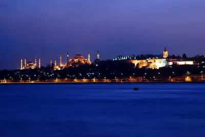 a view of a city at night from the water at Hotel Erden Sarayevo in Istanbul