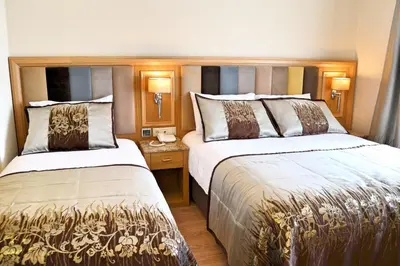 a hotel room with two beds in a room at Hotel Erden Sarayevo in Istanbul