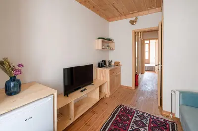 a living room with a flat screen tv on a wooden table at Applehill in Istanbul