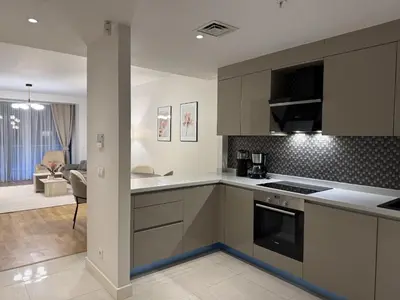 a kitchen with a stove top oven next to a living room at Taksim Petek Residence in Istanbul
