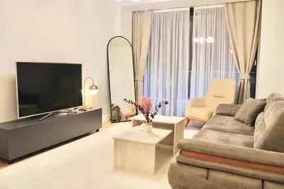 a living room with a couch and a television at Taksim Petek Residence in Istanbul