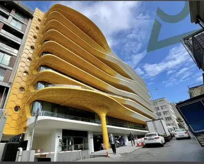 a yellow building with aavy roof on a city street at Taksim Petek Residence in Istanbul