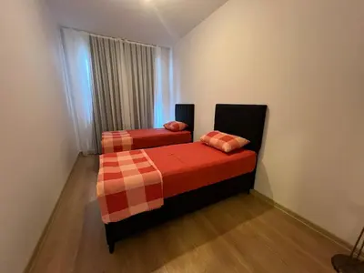 two beds in a small room with a window at Luxury Designed Comfortable 2 Rooms & 1 Living room Apartment Free Parking Garaj in Esenyurt