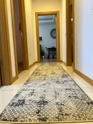a hallway with a black and white rug on the floor at Luxury Designed Comfortable 2 Rooms & 1 Living room Apartment Free Parking Garaj in Esenyurt