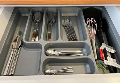 a tray with silver utensils in a drawer at Luxury Designed Comfortable 2 Rooms & 1 Living room Apartment Free Parking Garaj in Esenyurt
