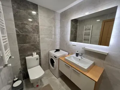 a bathroom with a washing machine and a sink at Luxury Designed Comfortable 2 Rooms & 1 Living room Apartment Free Parking Garaj in Esenyurt