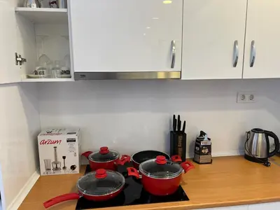 two pots and pans on a stove in a kitchen at Luxury Designed Comfortable 2 Rooms & 1 Living room Apartment Free Parking Garaj in Esenyurt