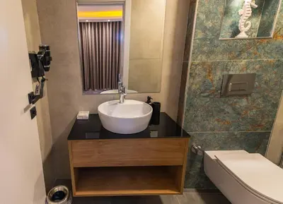 a bathroom with a sink and a toilet and a mirror at Huzur Apart Hotel in Istanbul