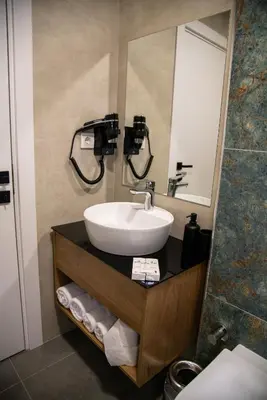 a bathroom with a sink and a mirror at Huzur Apart Hotel in Istanbul
