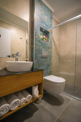 a bathroom with a sink and a toilet and a shower at Huzur Apart Hotel in Istanbul