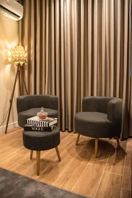 a room with two chairs and a table and a lamp at Huzur Apart Hotel in Istanbul