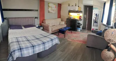 a bedroom with a bed and a couch and a chair at Mavi köşk in Bursa