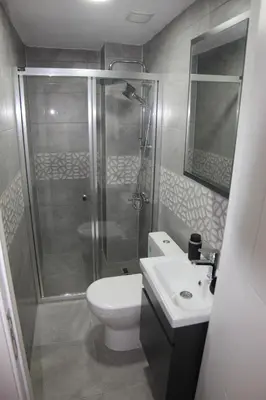 a bathroom with a shower and a toilet and a sink at erdener suits in Istanbul