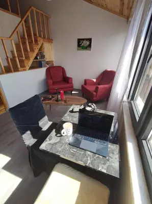 a living room with a table with a laptop on it at erdener suits in Istanbul