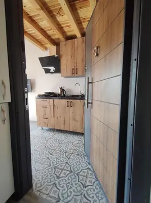 a kitchen with wooden cabinets and a counter top at erdener suits in Istanbul