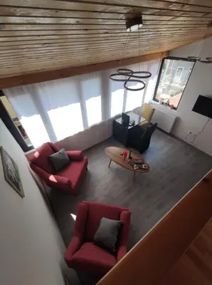 an overhead view of a living room with red chairs and a table at erdener suits in Istanbul