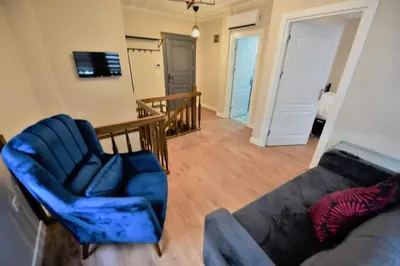 a living room with a couch and a chair at A spacious 3 rooms duplex close to İstiklal Boulevard in Istanbul