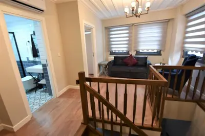 a living room with a staircase and a couch at A spacious 3 rooms duplex close to İstiklal Boulevard in Istanbul
