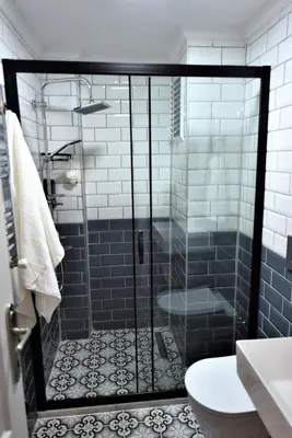 a shower with a glass door in a bathroom at A spacious 3 rooms duplex close to İstiklal Boulevard in Istanbul