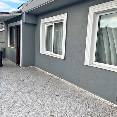 a gray house with two windows and a sidewalk at Elite Dumanlar in Istanbul