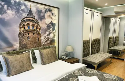 a bedroom with a bed with a picture of a tower at Elite Dumanlar in Istanbul