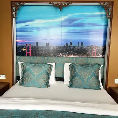 a bed with a large window with a view of a city at Elite Dumanlar in Istanbul
