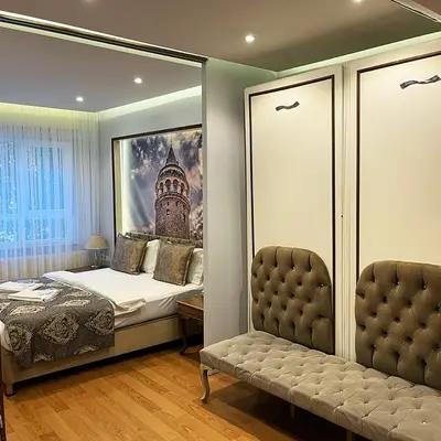 a bedroom with a bed and a picture on the wall at Elite Dumanlar in Istanbul