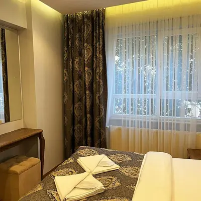 a bedroom with a bed with a window and a table at Elite Dumanlar in Istanbul
