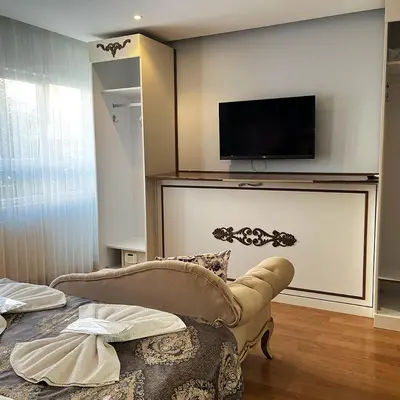 a living room with a couch and a tv on a wall at Elite Dumanlar in Istanbul