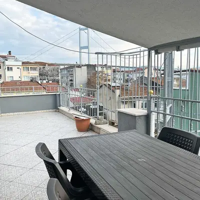 a table on a balcony with a view of a city at Elite Dumanlar in Istanbul