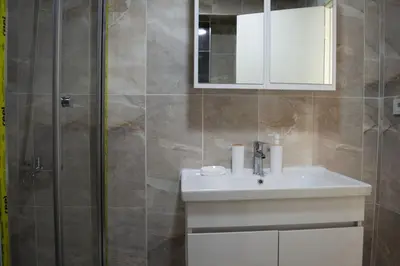 a bathroom with a sink and a shower at Luxe Suite AY37 in Eskiömerler